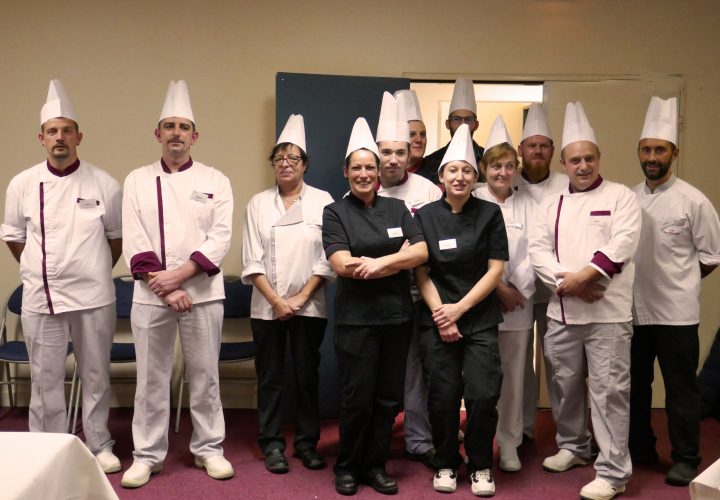 Un groupe de chefs posant pour une photo.